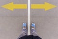 Arrows on asphalt ground, feet and shoes on floor Royalty Free Stock Photo