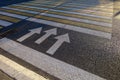 Arrows on the asphalt on the pedestrian crossing