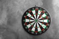 Arrows hitting dart board on grey wall. Space for Royalty Free Stock Photo