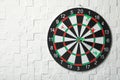 Arrows hitting dart board on white textured wall.  for text Royalty Free Stock Photo