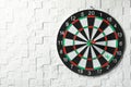 Arrows hitting dart board on white textured wall.  for text Royalty Free Stock Photo