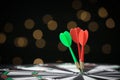 Arrows hitting target on dart board against blurred . Space for text Royalty Free Stock Photo
