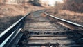 The arrows of the old railway of an industrial enterprise go into the distance on a blurred background, bottom view, beautiful