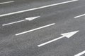 Arrows signs on an urban asphalt road