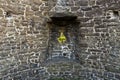 Arrowslit defense in stone tower of medieval castle fortress