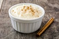 Arroz con leche. Rice pudding with cinnamon on wood