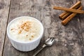 Arroz con leche. Rice pudding with cinnamon on wood