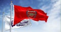 Arsenal Football Club and Premier League flags waving on a clear day