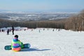 Arsenyev, Russia, January, 28, 2017. Snowboarder siting on the teaching slope. Ski resort in the town of Arsenyev.