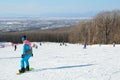 Arsenyev, Russia, January, 28, 2017. Young woman snowboarding on the teaching slope. Ski resort in the town of Arsenyev