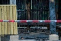 Arson crime scene with german police cordon or barrier tape in front of it