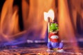 Arsonist on fire. A crocodile toy stands with a match in a fiery flame. Fire and fire concept