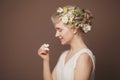 Art beauty portrait of a woman with butterflies and white flower smiling on brown background Royalty Free Stock Photo