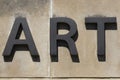 ART block letter word in black on a sandstone background.