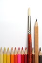 Art brush and simple pencil for plotting among colour pencils Royalty Free Stock Photo