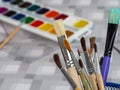 Art brushes on the background of watercolor paints. A set of watercolor paints and brushes for painting Royalty Free Stock Photo