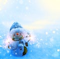 Art Christmas snowman and sparklers on blue snow background Royalty Free Stock Photo