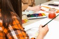 Art class in school, artist student paints in studio. Painting in classroom. Female hand with paintbrush Royalty Free Stock Photo