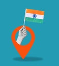 Art collage, hand with Indian flag on blue background with navigation sign Royalty Free Stock Photo