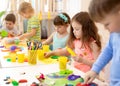 Art and craft activity in kindergarten. Group of preschool kids hands working in daycare center. Royalty Free Stock Photo