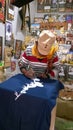 An artist is painting on on the fabric in his little workshop