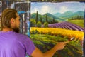 Art creative process. Artist create painting Italian summer countryside. Tuscany. Field of red poppies, a field of yellow rye. Rur