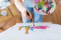 Artist with palette and brush painting at studio Royalty Free Stock Photo