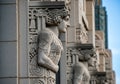 Art Deco architectural elements on a building, featuring detailed stone reliefs of stylized human Royalty Free Stock Photo