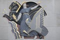 Art Deco bas-relief building traditional woman holding flame, olive branch, peace symbol. mythological horse Pegasus and