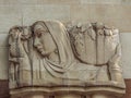 Art Deco bas relief sculpture showing a woman carrying a sheaf of wheat