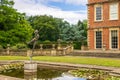 Art deco bronze sculpture surrounded by water lilies at the historic Newby Hall park.