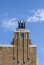 Art Deco building with birds perched on roof under pretty blue sky