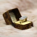 Art deco diamond ring in antique box on rose fur Royalty Free Stock Photo