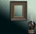 Art deco empty frame on green damask and oil lamp Royalty Free Stock Photo