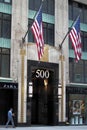 Art Deco entrance doorway and lanterns of the building at 500 5th Avenue, decorated with the US flags, New York