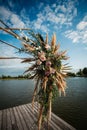 Art Deco wedding arch with pink roses and leaves on a wooden platform for the ceremony Royalty Free Stock Photo