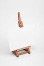 Art easel with white card. Royalty Free Stock Photo