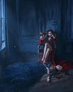 Woman vamp Holding glass Blood wine. at feet lies sleeping beauty dead princess