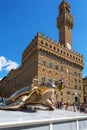 Art exhibition in front of the Palazzo Vecchio in Florence with a bronze turtle