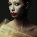 Art fashion concept. Portrait of sensual beautiful brunette looking at camera through the black veil and posing over dark gray Royalty Free Stock Photo