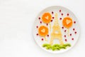 Art food concept. Eiffel Tower with silhouette of a couple in love and heart shaped balls. Lace pancakes with pomegranate seeds. Royalty Free Stock Photo