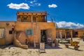 Art gallery open at the ancient adobe Taos Pueblo where indigenous people have lived for over 1000 years - door standing open and Royalty Free Stock Photo