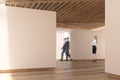 Art gallery wooden floor, ceiling, people, side