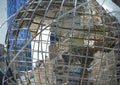 Art globe sculpture with a blue glass building in the background. Royalty Free Stock Photo