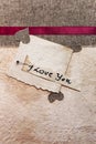 Art greeting card on vintage background (heart, old paper, fabric) Royalty Free Stock Photo