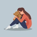 Sad crying lonely depressed girl hugging a bear Royalty Free Stock Photo