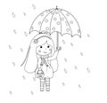 Cute little happy girl with umbrella and basket with halloween candies enjoying rain.