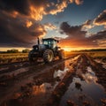Agricultural workers with tractors. Ploughing a field with tractor at sunset Royalty Free Stock Photo