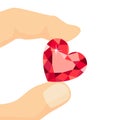 Hand holding red heart shaped diamond isolated on white background. Royalty Free Stock Photo