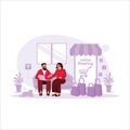 Married Couple Shopping Online On Laptop With Colorful Shopping Bags On Sofa. online shopping concept. Royalty Free Stock Photo